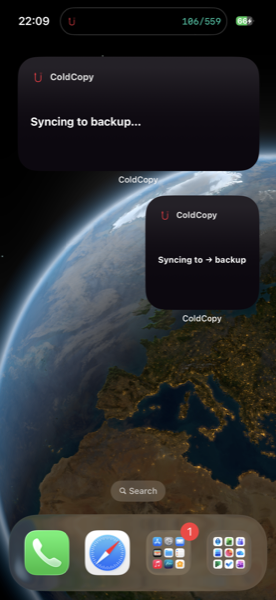 Home screen showing ColdCopy Live Activity notification — Syncing to backup 106/559